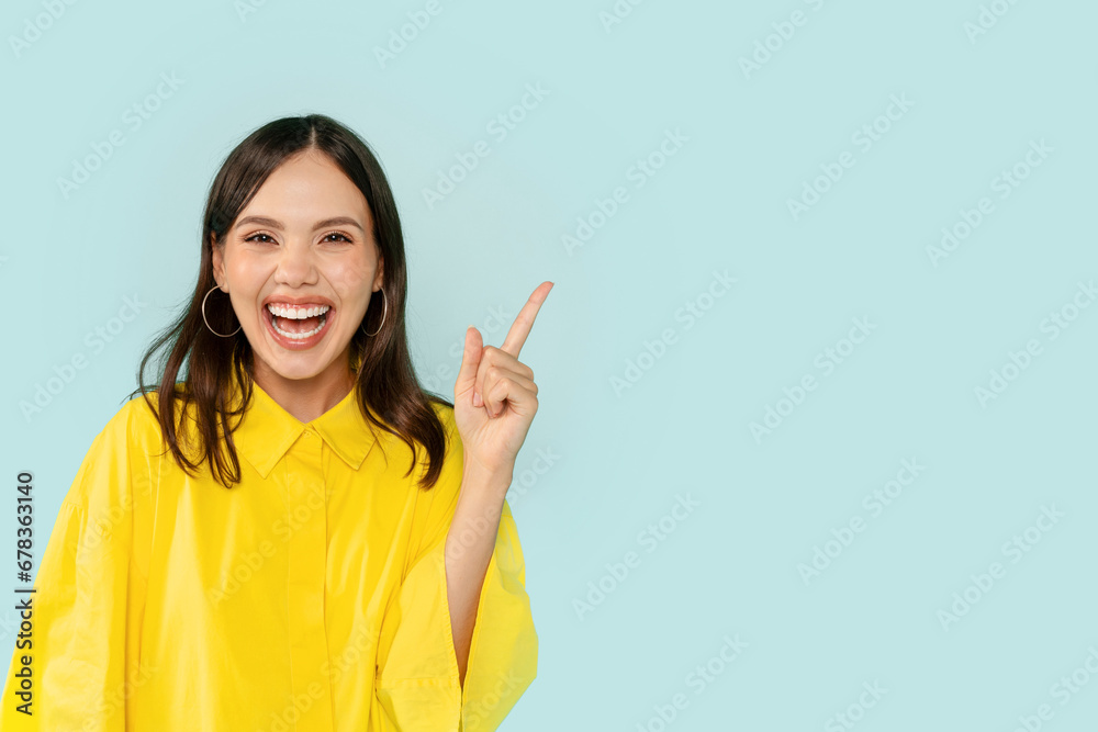 Emotional young woman showing eureka gesture and laughing Emotional young woman showing eureka gesture and laughing