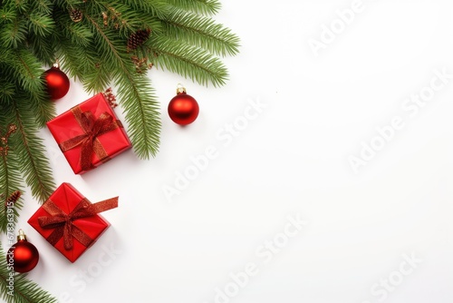Christmas decorations such as red gifts and baubles with pine branches frame isolated on white background