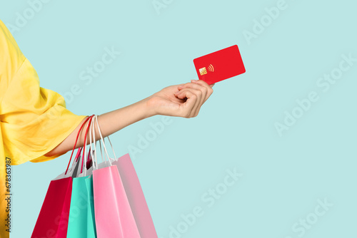 Woman hand holding purchases and credit card