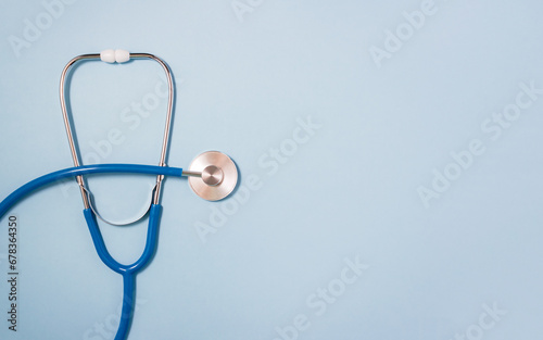 Stethoscope close-up on blue backdrop. Medical background. Selective focus, copy space