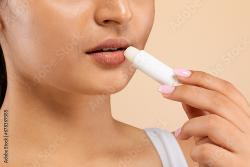 Lip Care. Indian Female Using Chapstick To Moisturize Her Beautiful Plump Lips