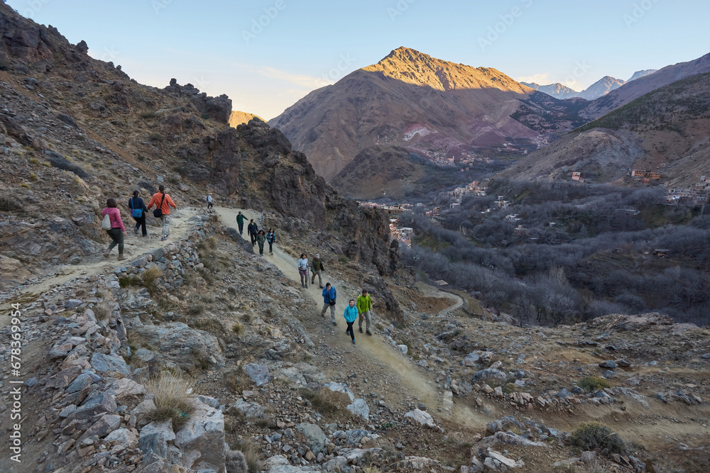 A group of tourists trekking through the stunning Atlas Mountains in Morocco