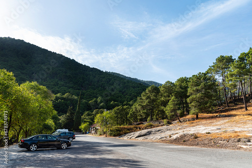 Several cars parked in a rural countryside