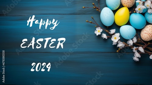 Festive Easter Greetings with Colorful Eggs and Spring Blossoms on Blue Wooden Background 2024