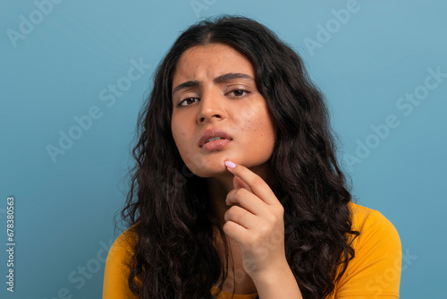 Stressed sad brunette young woman touching her face
