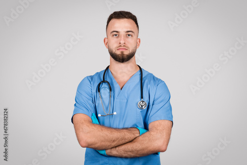 Confident male nurse with arms crossed photo