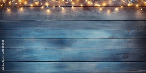 Christmas Light on Blue Wooden Background Top View with Copyspace. Garland Lights on Vintage Wood