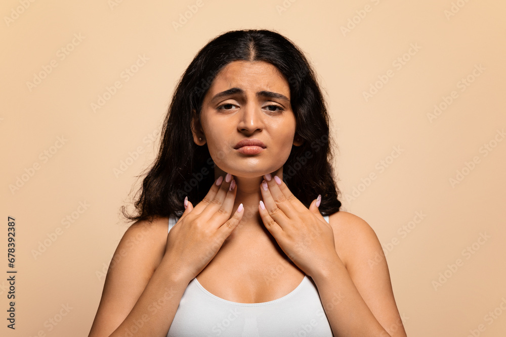 Portrait of unhappy sad sick indian woman suffering from sore throat Portrait of unhappy sad sick indian woman suffering from sore throat
