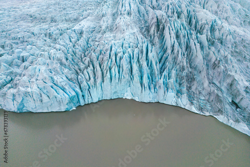 Aerial view of ice cap and sea with icebergs photo