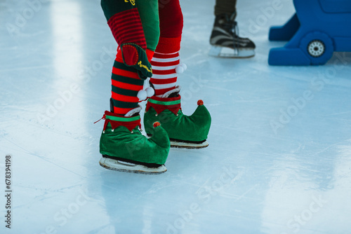 Elf-themed ice skates on festive rink surface photo