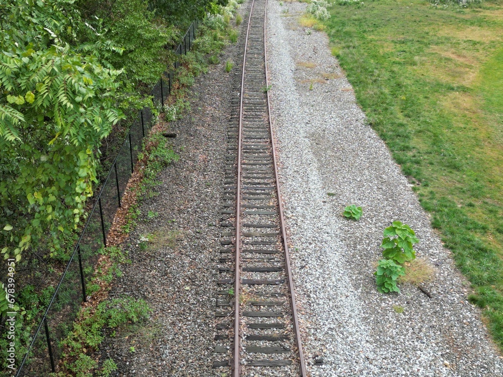 High-angle shot of a railroad next to a field High-angle shot of a railroad next to a field