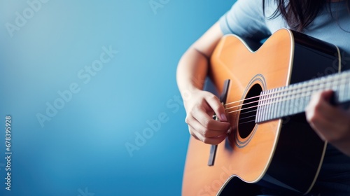A skilled musician captivates the audience with their acoustic guitar, producing enchanting music through their skilled playing. photo