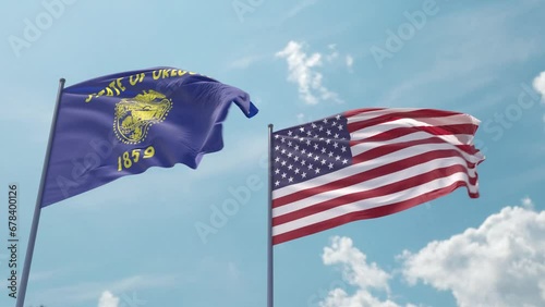 Oregon flag and the USA flag on a flagpole realistic wave on strong wind in blue sky as a screensaver or intro. State of Oregon and The United States of America