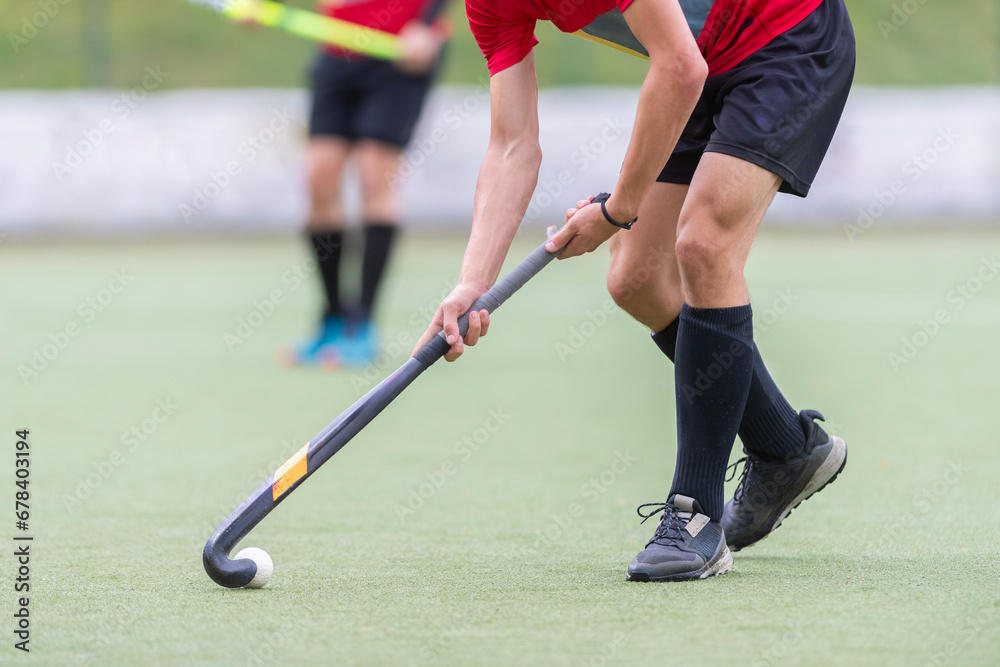 Obraz premium Field Hockey player, ready to pass the ball to a team mate. Horizontal sport theme poster, greeting cards, headers, website and app
