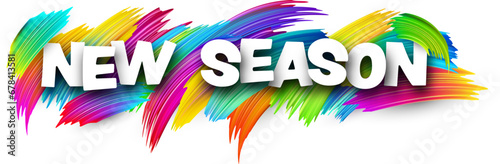 New season paper word sign with colorful spectrum paint brush strokes over white.