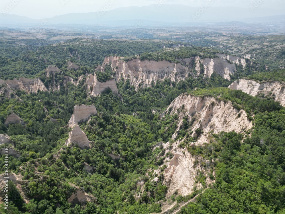Aerial shot of the pyramids of Melnik and green trees on a summer day, Bulgaria Aerial shot of the pyramids of Melnik and green trees on a summer day, Bulgaria