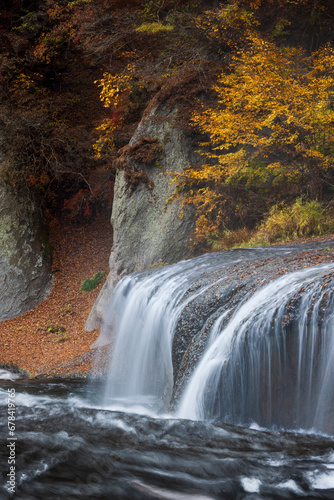 Beautiful cascade waterfall surrounded by autumn colors