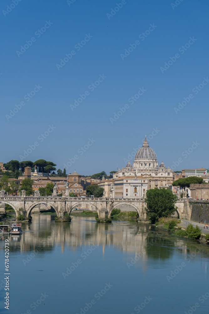 Beautiful view of a bridge over the Tiber river and St. Peter's Basilica in Rome, Italy