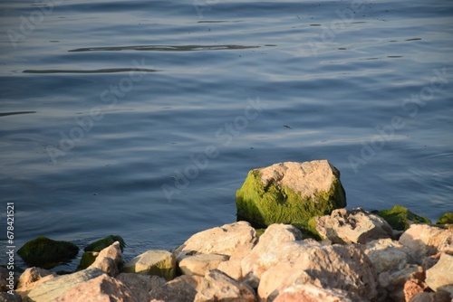 Closeup of rocks on the shore of a lake