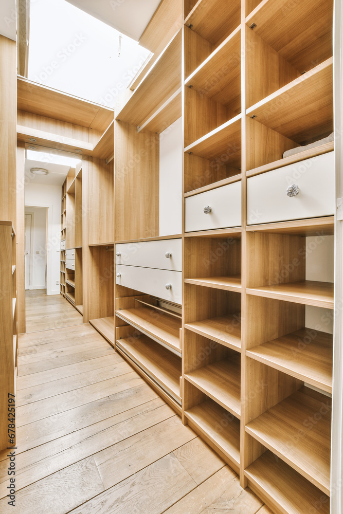 Modern walk in large empty wardrobe with wooden shelves Modern walk in large empty wardrobe with wooden shelves