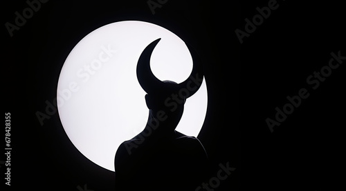 Silhouette of horned devil demon figure on white circle background cutout 