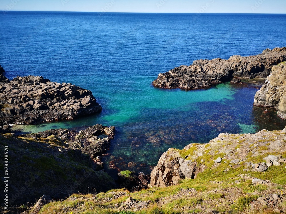 Tranquil blue beach with large boulders Tranquil blue beach with large boulders