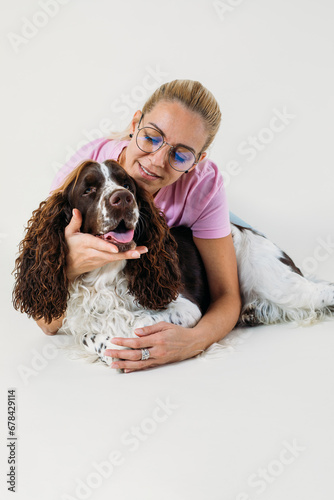 Woman and her dog in studio.
Portrait of cute young woman sitting on floor in studio with her beautiful doggie

