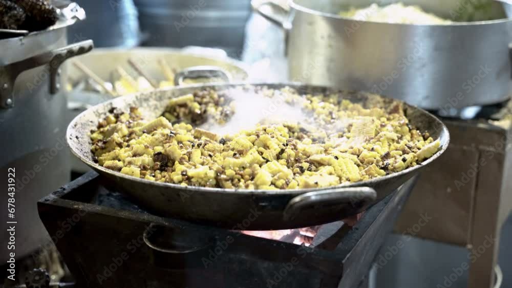 Shallow focus of delicious grilled corn in a big metal bowl in the street market of Guanajuato Shallow focus of delicious grilled corn in a big metal bowl in the street market of Guanajuato