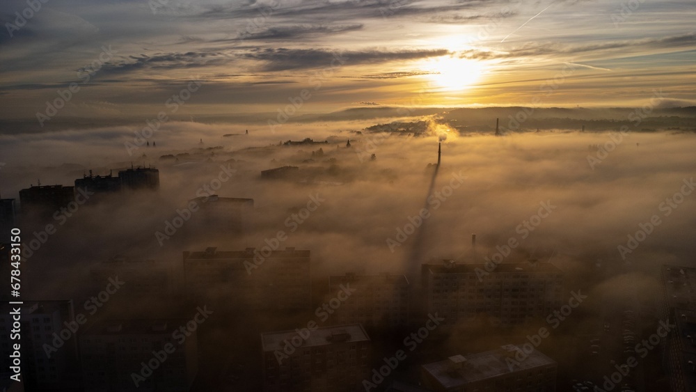 Drone shot of the Litomerice town covered with dense fog in the early morning in the Czech Republic Drone shot of the Litomerice town covered with dense fog in the early morning in the Czech Republic