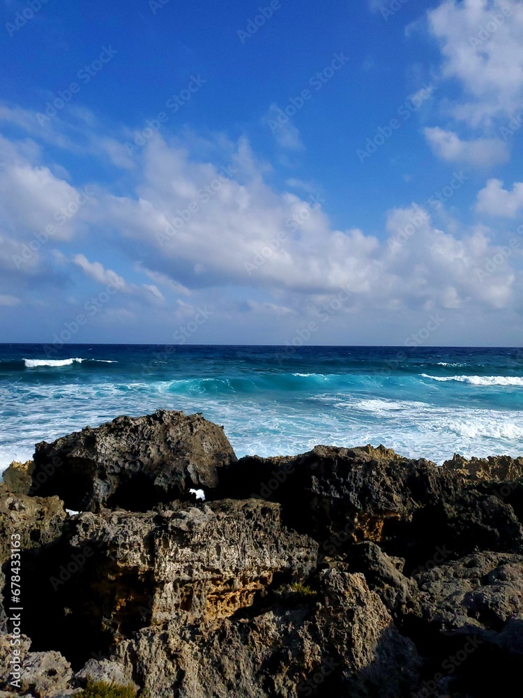 Vertical shot of a rocky coast of a sea on a bright sunny day Vertical shot of a rocky coast of a sea on a bright sunny day