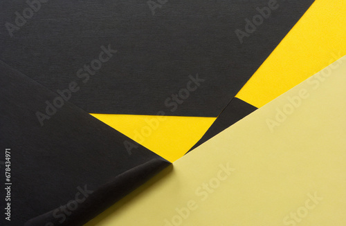 Stacked yellow and black smooth paper forms an unusual background.