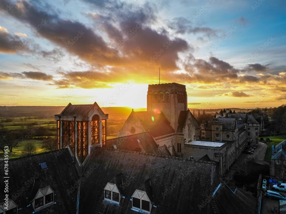 Drone shot of the roofs of big houses and the Ampleforth Abbey in the UK at sunset - obrazy, fototapety, plakaty 