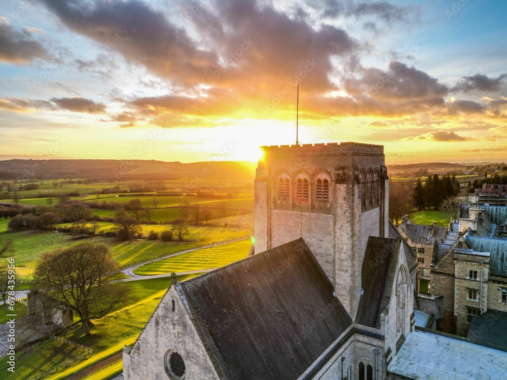 Drone shot of the roofs of big houses and the Ampleforth Abbey in a UK at sunset - obrazy, fototapety, plakaty 