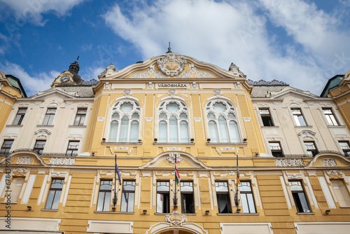 Main facade of the city hall of Pecs, Hungary, with the mention Varoshaza in hungarian meaning, town hall. It's the head of Pec city administration and a neo baroque landmark. photo