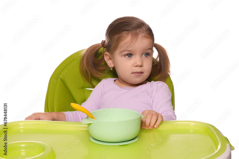 Cute little child with bowl of tasty yogurt in high chair on white background Cute little child with bowl of tasty yogurt in high chair on white background