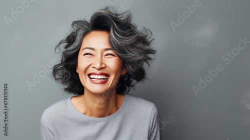 portrait of a happy smiley asian older lady grey background isolated photo