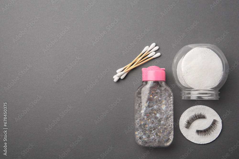 Flat lay composition with makeup removal tools and false eyelashes on dark grey background. Space for text Flat lay composition with makeup removal tools and false eyelashes on dark grey background. Space for text