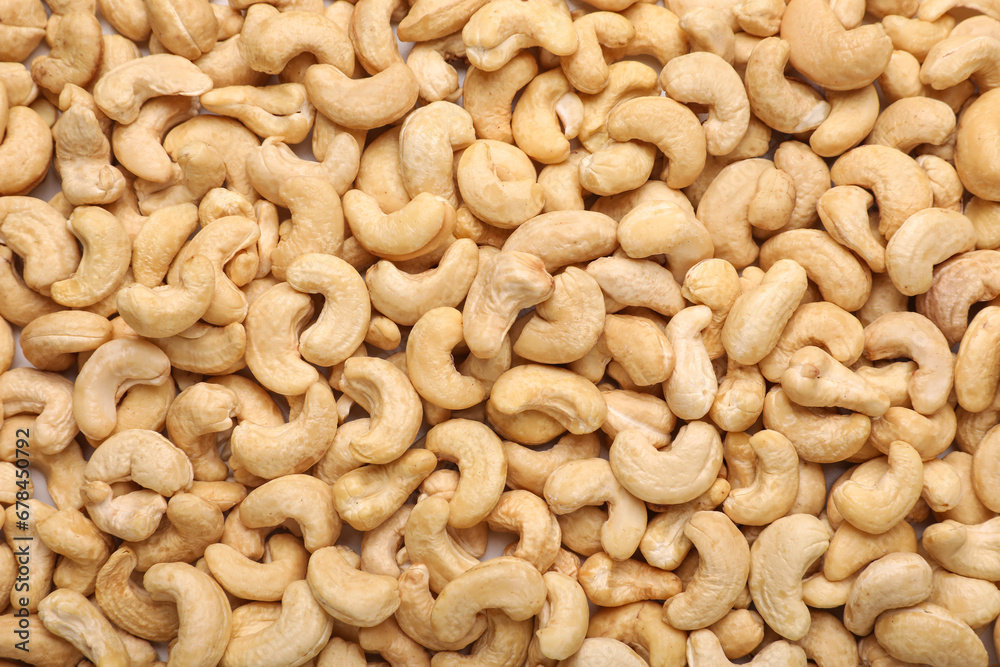 Many tasty cashew nuts as background, top view Many tasty cashew nuts as background, top view