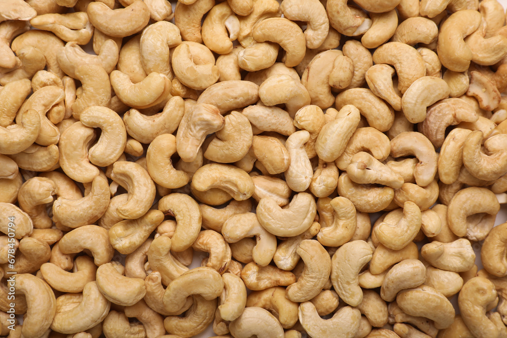 Many tasty cashew nuts as background, top view