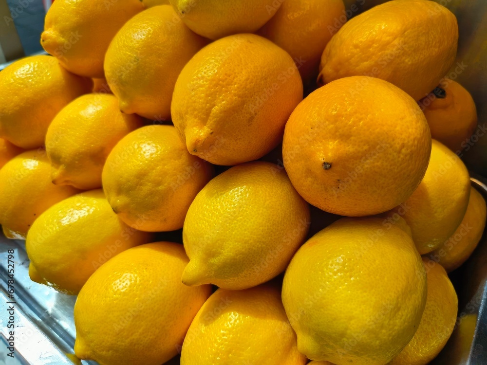 Lemons on display in a market, closeup of photo