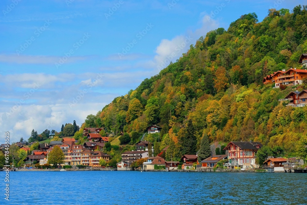 Swiss houses and buildings surround elevated hill on blue sky background 2