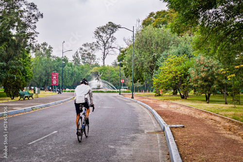 person riding a bike in chapultepec park in mexico city 