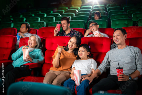 Happy group of asian family and grandmother relax and go to Cimema in movie theater