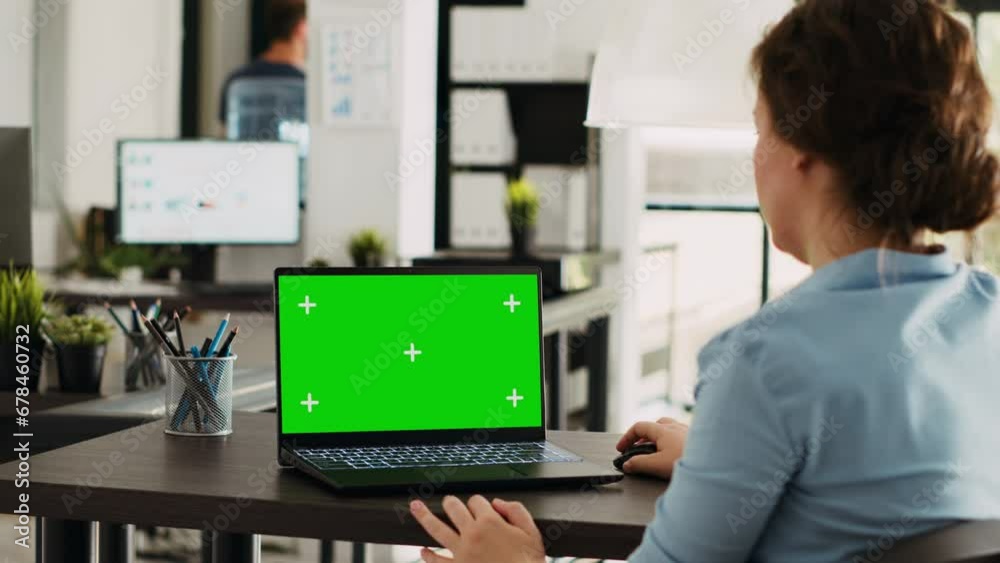 Manager working at office desk with greenscreen on laptop, analyzing mockup chromakey display and isolated copyspace template. Woman using personal computer at workstation. Manager working at office desk with greenscreen on laptop, analyzing mockup chromakey display and isolated copyspace template. Woman using personal computer at workstation.