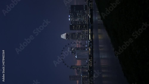 vertical view of Singapore skyline city at riverfront of singapore river with modern office highrise skyscraper financial buildings in central business district in night time photo