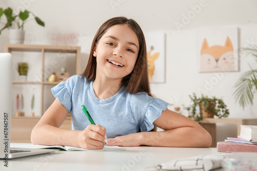 Little girl doing lessons at home