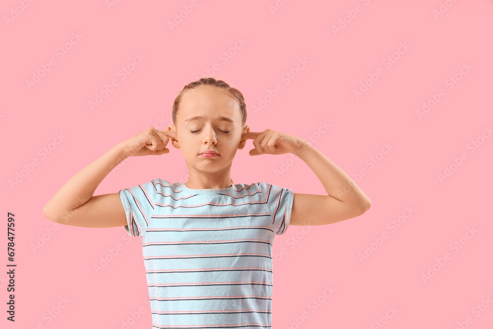 Little girl covering ears on pink background Little girl covering ears on pink background