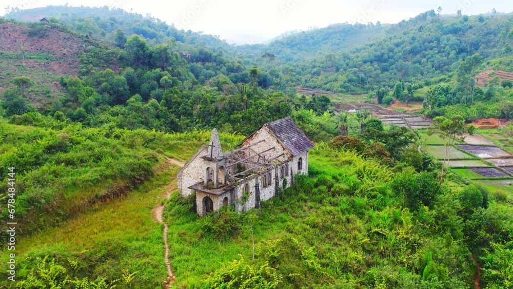 Old church with broken roof in the middle of the green jungle. Tropical forest with an old empty building made of stones - Aerial shot. Old church with broken roof in the middle of the green jungle. Tropical forest with an old empty building made of stones - Aerial shot.