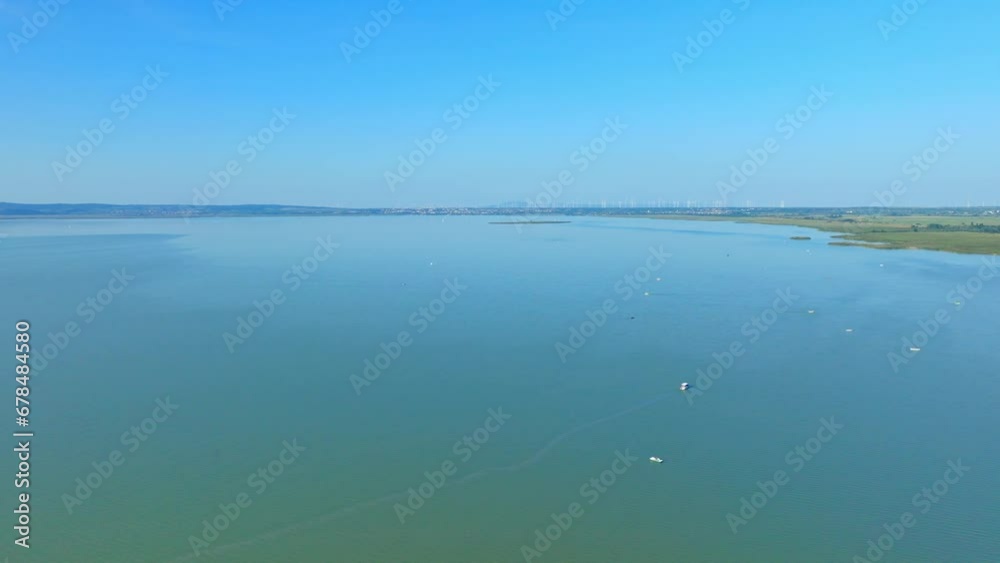 Boats Floating On Calm Waters Of Lake Neusiedl In Austria. aerial Boats Floating On Calm Waters Of Lake Neusiedl In Austria. aerial