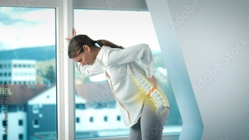 Young businesswoman in office bends forward with back pain. Concept of incorrect posture and sitting position. Animation of spine, medical problem photo